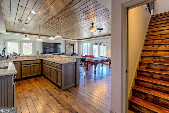 537 Mill Ridge Rd, Hiawassee, GA 30546 - kitchen featuring dark wood-style floors, hanging light fixtures, wood ceiling, and light stone countertops