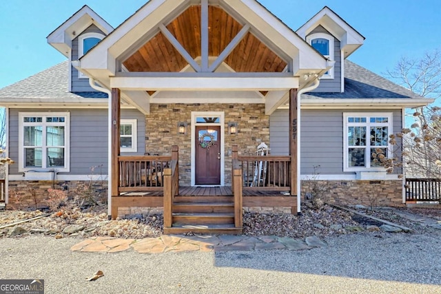 537 Mill Ridge Rd, Hiawassee, GA 30546 - craftsman-style home featuring stone siding, a shingled roof, and a porch