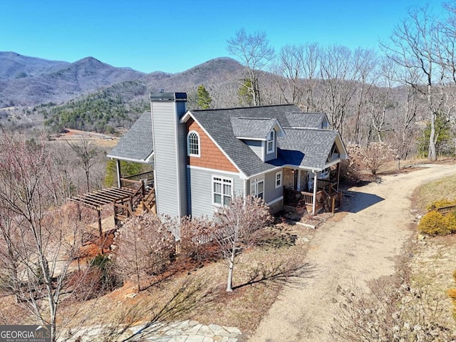 537 Mill Ridge Rd, Hiawassee, GA 30546 - view of front of property featuring roof with shingles, driveway, a chimney, and a mountain view