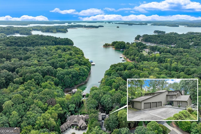 aerial view featuring a water view and a wooded view