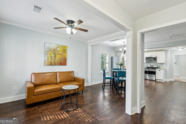 living area featuring baseboards, dark wood-style flooring, visible vents, and crown molding