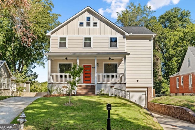 view of front facade featuring driveway, a porch, board and batten siding, and a front yard