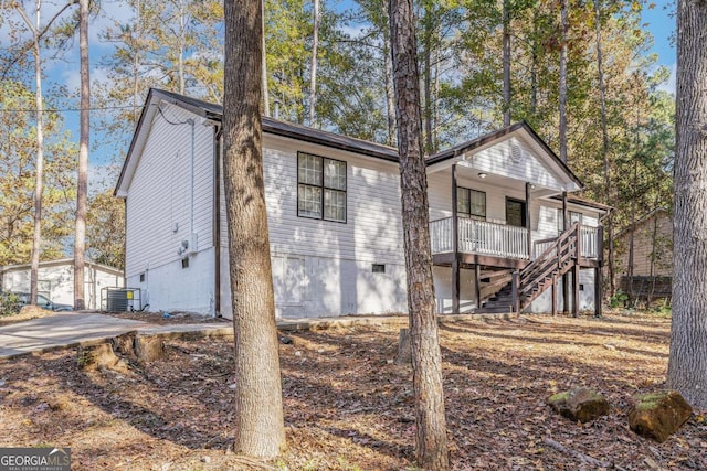 exterior space featuring crawl space, central AC, and stairway