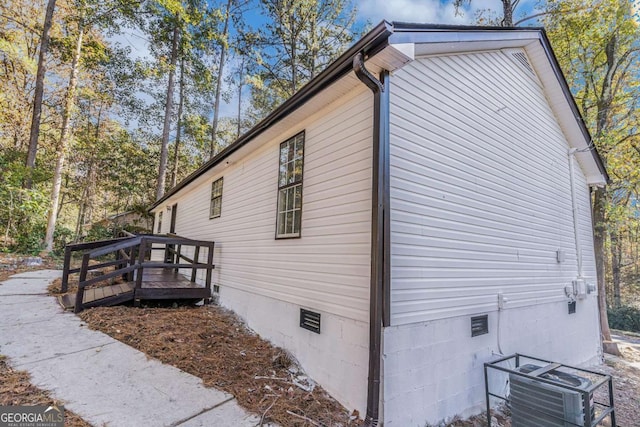 view of home's exterior featuring crawl space, a deck, and cooling unit