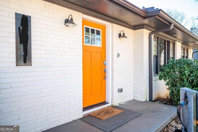 entrance to property with brick siding