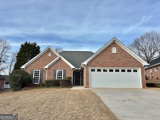 single story home with brick siding, driveway, and an attached garage