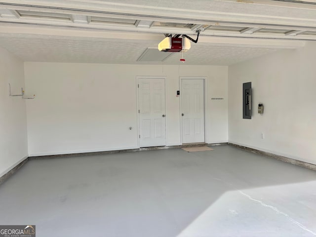 garage featuring electric panel, baseboards, and a garage door opener