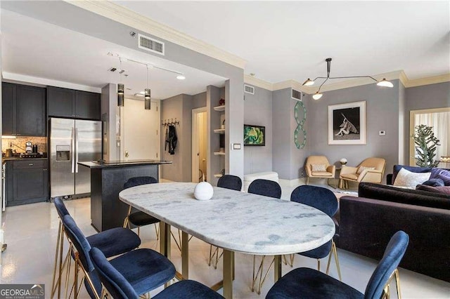 dining space featuring visible vents and crown molding