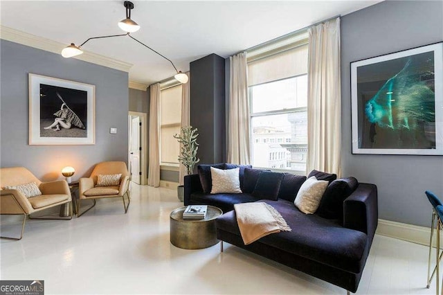 living area featuring baseboards and crown molding