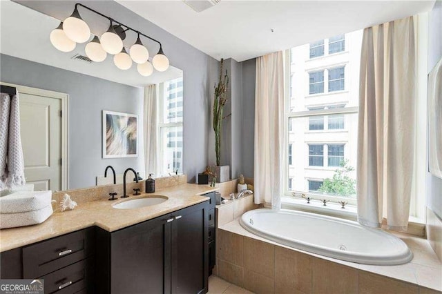 bathroom featuring vanity, a garden tub, and visible vents