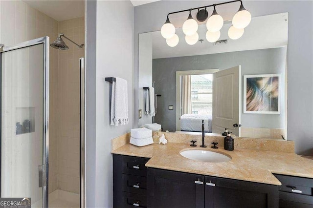 ensuite bathroom featuring a shower stall, visible vents, connected bathroom, and vanity