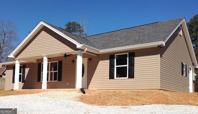 view of front of house featuring covered porch and a shingled roof