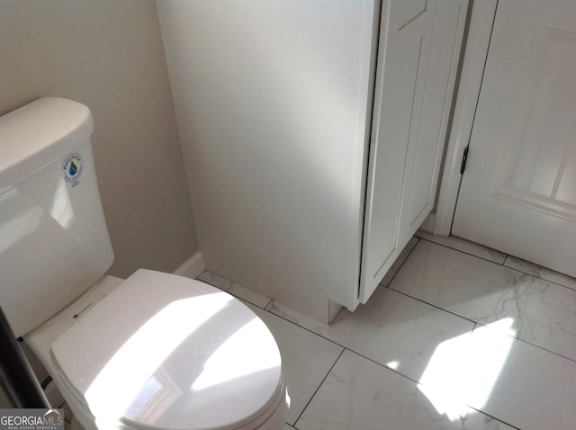 bathroom featuring marble finish floor and toilet