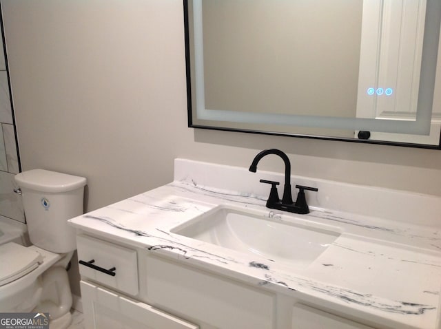 bathroom with toilet and vanity