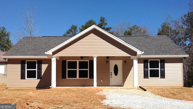 ranch-style house featuring roof with shingles