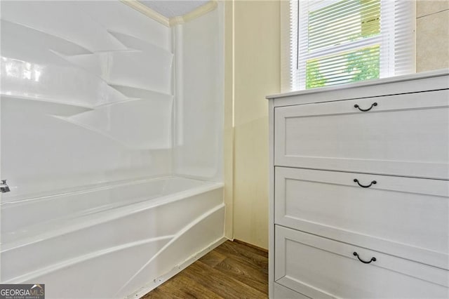 bathroom featuring shower / washtub combination and wood finished floors