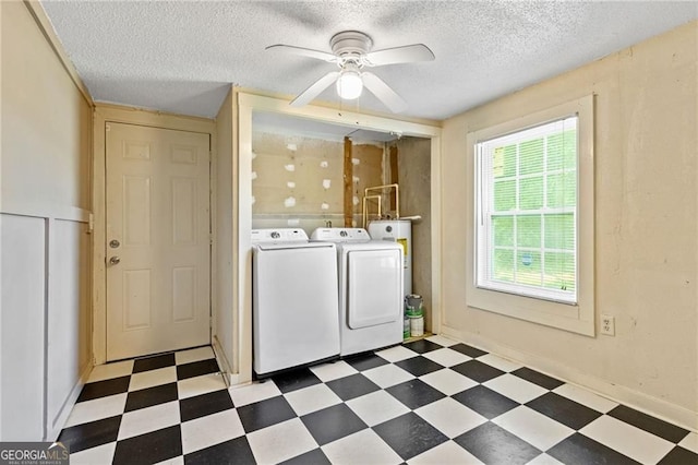 clothes washing area with a ceiling fan, a textured ceiling, laundry area, independent washer and dryer, and tile patterned floors