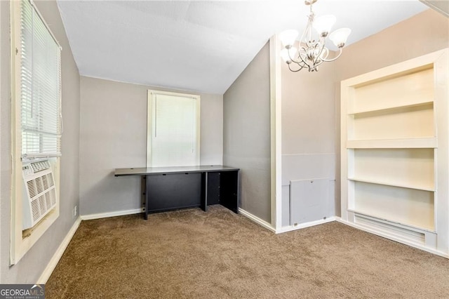 unfurnished office featuring vaulted ceiling, carpet floors, an inviting chandelier, and baseboards