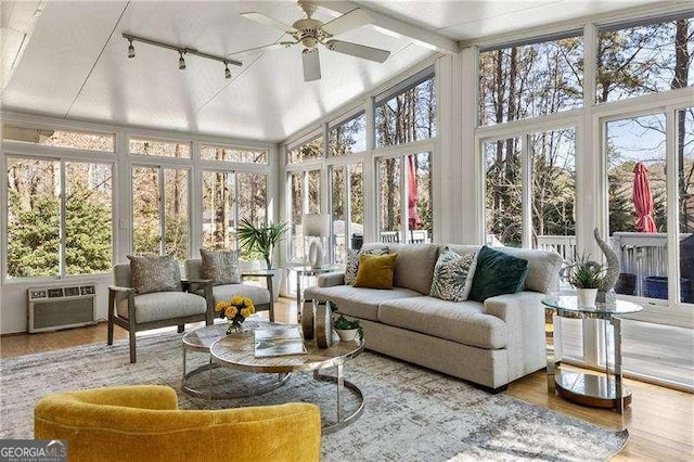 sunroom / solarium featuring a ceiling fan, a wall unit AC, and track lighting