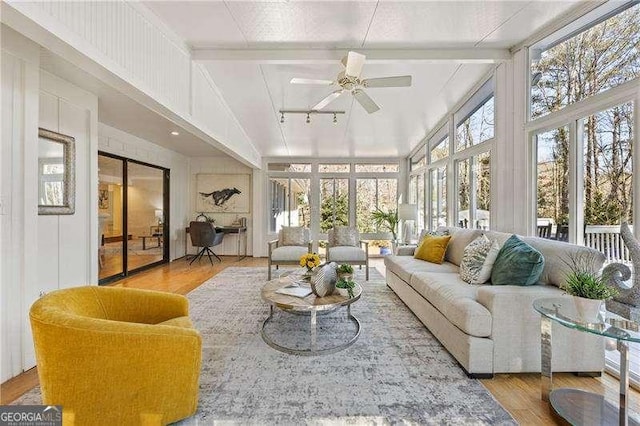 sunroom / solarium with lofted ceiling with beams and ceiling fan