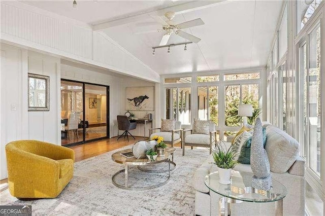 sunroom featuring a ceiling fan and vaulted ceiling