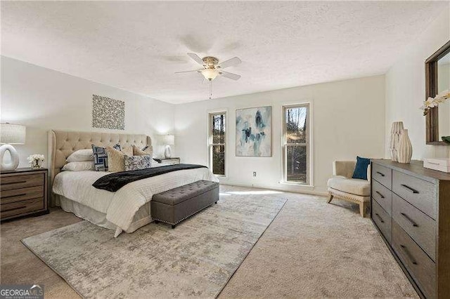 carpeted bedroom with a textured ceiling and ceiling fan