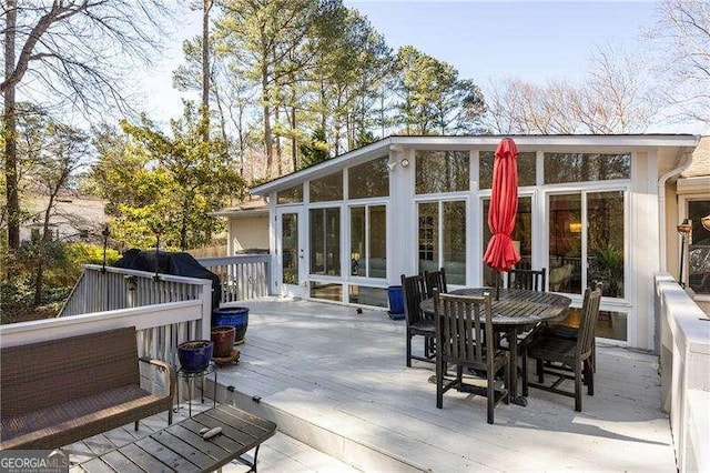 wooden deck with a sunroom