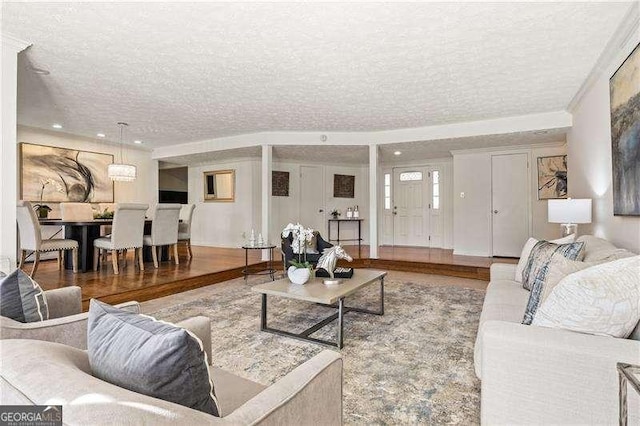 living room with recessed lighting, a textured ceiling, and wood finished floors