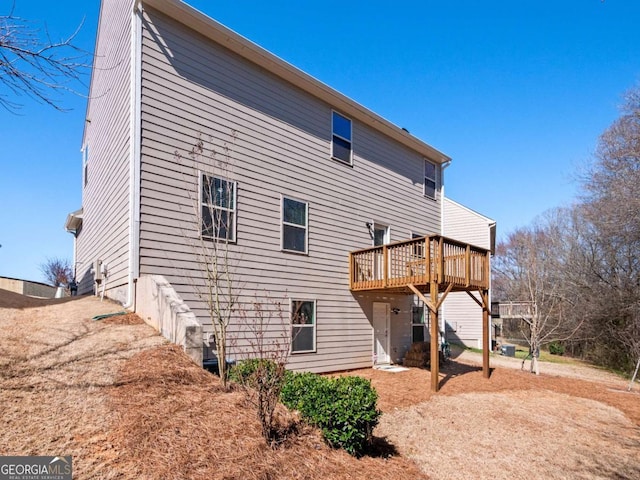 rear view of house with a wooden deck