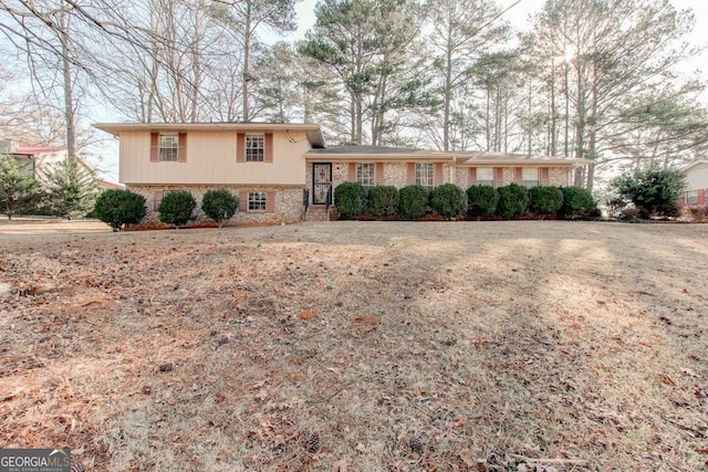 split level home with brick siding