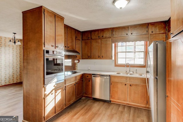 123 Creek Cir, Stockbridge, GA 30281 - kitchen featuring light wood-type flooring, stainless steel appliances, a sink, and light countertops