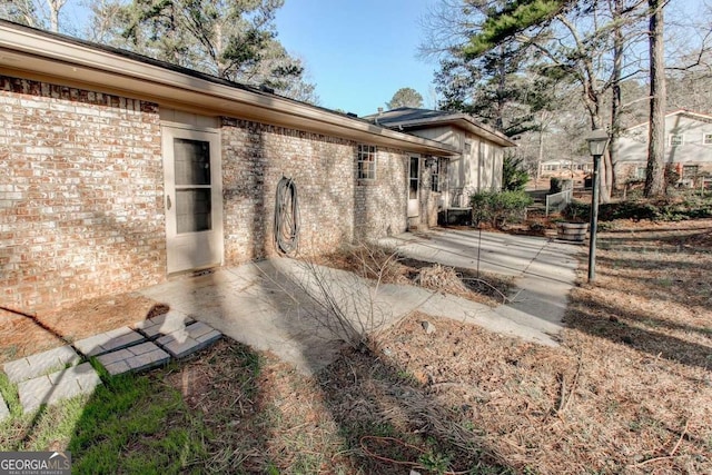 123 Creek Cir, Stockbridge, GA 30281 - exterior space featuring a patio area and brick siding