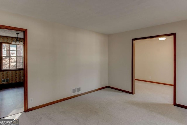 123 Creek Cir, Stockbridge, GA 30281 - carpeted spare room with baseboards, visible vents, and a chandelier