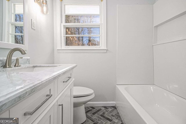 full bathroom featuring baseboards, vanity, and toilet