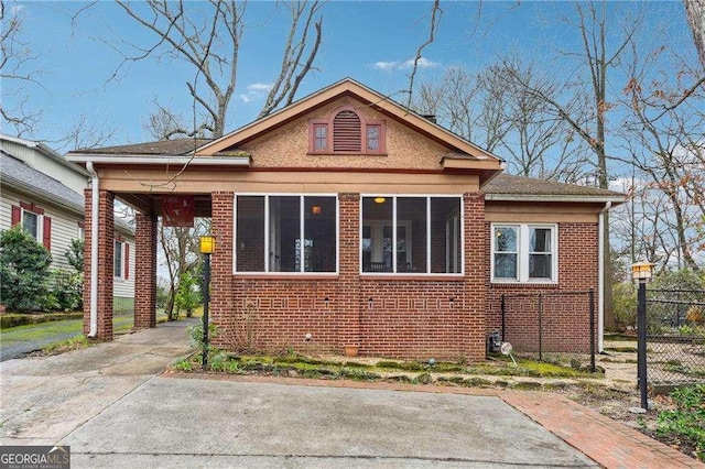 exterior space featuring brick siding and fence