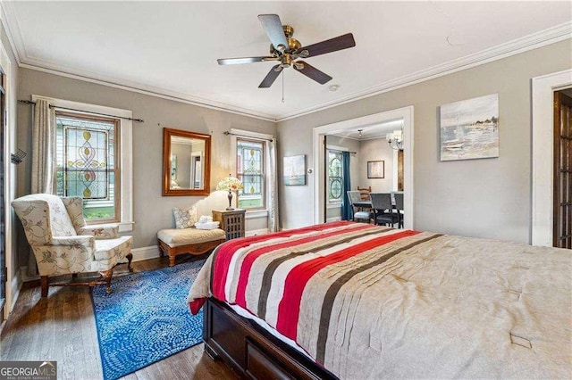 bedroom with ceiling fan, wood finished floors, baseboards, and ornamental molding