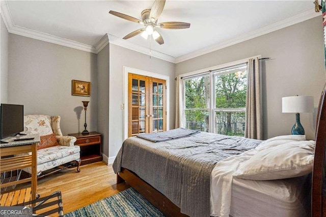 bedroom featuring baseboards, ornamental molding, french doors, light wood-style floors, and a ceiling fan