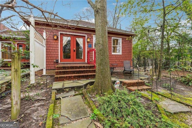 view of outbuilding featuring entry steps and french doors