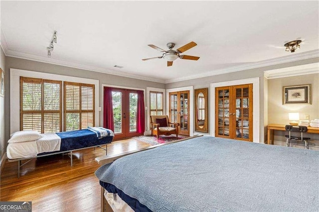 bedroom with access to outside, french doors, crown molding, and wood finished floors