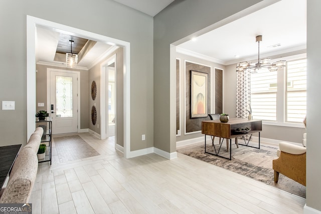 foyer entrance with a healthy amount of sunlight, a chandelier, and ornamental molding