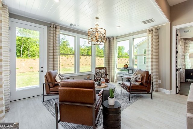 sunroom featuring wooden ceiling, visible vents, and a chandelier