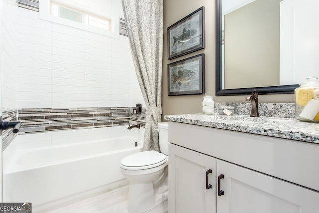 full bath featuring toilet, shower / bath combination with curtain, and vanity