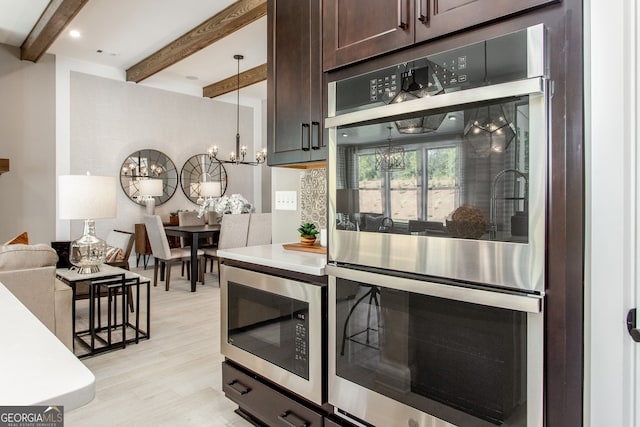 kitchen featuring dark brown cabinetry, light wood finished floors, appliances with stainless steel finishes, light countertops, and beam ceiling