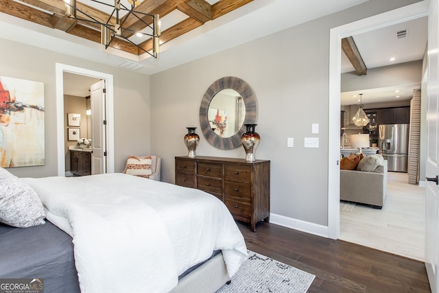 bedroom featuring wood finished floors, visible vents, baseboards, beam ceiling, and stainless steel fridge with ice dispenser