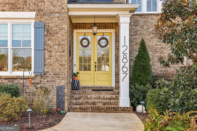 doorway to property with french doors and brick siding