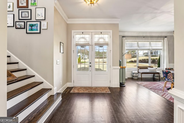 entrance foyer with baseboards, stairway, wood finished floors, crown molding, and french doors