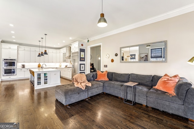 living area featuring ornamental molding, dark wood-style flooring, and recessed lighting