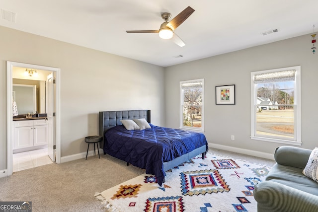 bedroom featuring light carpet, visible vents, and multiple windows