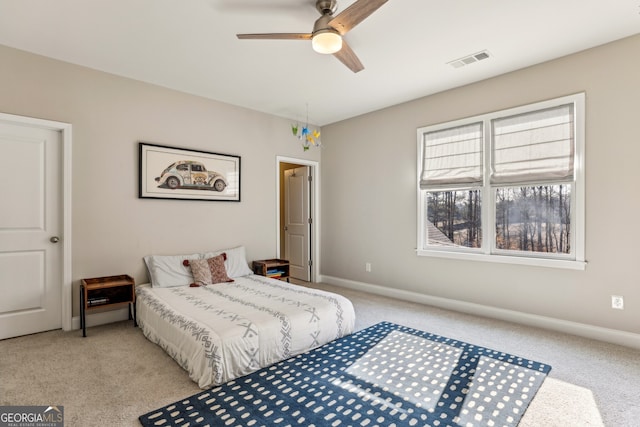 bedroom featuring light carpet, ceiling fan, visible vents, and baseboards