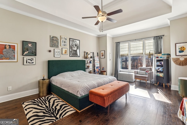 bedroom with a raised ceiling, baseboards, and wood finished floors